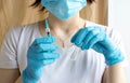 Nurse holds a syringe with a vaccine in her hand. Liquid in a syringe. Vaccination and healthcare. Medical concept. Doctor in Royalty Free Stock Photo