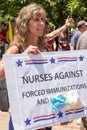 A Nurse Holds Up an Anti Vaccination/Mask Sign at a Conservative Rally Royalty Free Stock Photo