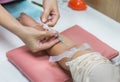 Nurse inject needle syringe in the arm drawing blood sample