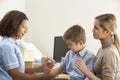 Nurse injecting child with mother Royalty Free Stock Photo