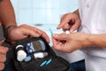 Nurse instructs blood sugar testy pointing to needle