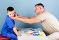 Nurse laboratory assistant. family doctor. small boy with dad play. Future career. happy child with father with Royalty Free Stock Photo