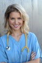 Nurse with long blonde hair and a stethoscope in a uniform smiling at the camera Royalty Free Stock Photo