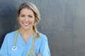 Nurse with long blonde hair and a stethoscope in a uniform smiling at the camera Royalty Free Stock Photo