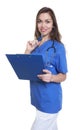 Nurse with long dark hair and Clipboard looking at camera Royalty Free Stock Photo