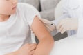 The nurse makes an insulin injection to the boy. A nurse is sitting in a mask and gloves at the table. Royalty Free Stock Photo