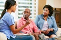 Nurse Making Notes During Home Visit With Senior Couple Royalty Free Stock Photo