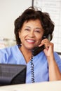 Nurse Making Phone Call At Nurses Station Royalty Free Stock Photo