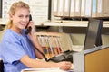 Nurse Making Phone Call At Nurses Station Royalty Free Stock Photo