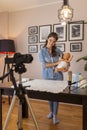 Influencer recording video about newborn baby double diapering Royalty Free Stock Photo