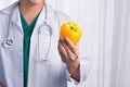 Nurse or male doctor giving bell pepper smiling. Health care con Royalty Free Stock Photo