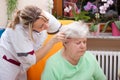 Nurse massages the head of a senior Royalty Free Stock Photo