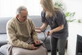 Nurse measure high blood pressure of a sick senior mature male patient in medical clinic closeup. Doctor checking Royalty Free Stock Photo