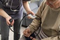 Nurse measure high blood pressure of a sick senior mature male patient in medical clinic closeup. Doctor checking Royalty Free Stock Photo