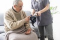 Nurse measure high blood pressure of a sick senior mature male patient in medical clinic closeup. Doctor checking Royalty Free Stock Photo