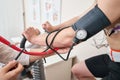 The nurse measures arterial tension. Man patient, pedaling on a bicycle ergometer stress test system for the function of