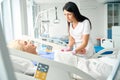 Nurse measures a patients blood pressure after surgery