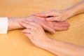 Nurse measures pulse of elderly woman