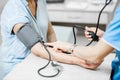 Nurse measuring blood pressure of a senior patient Royalty Free Stock Photo