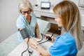 Nurse measuring blood pressure of a senior patient Royalty Free Stock Photo