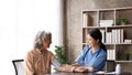 Nurse measuring blood pressure of senior woman. Smiling to each other. Doctor checking elderly woman's blood Royalty Free Stock Photo