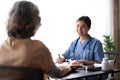 Nurse measuring blood pressure of senior woman. Smiling to each other. Doctor checking elderly woman's blood Royalty Free Stock Photo