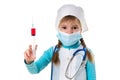 Nurse with medical face mask, holding syringe with a red liquid vertically, looking at the camera, on white landscape Royalty Free Stock Photo