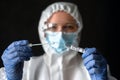 Nurse in medical PPE suit holds tube of coronavirus PCR test Royalty Free Stock Photo