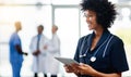 Nurse, medical professional and healthcare worker with tablet and afro feeling happy after checking positive test result Royalty Free Stock Photo