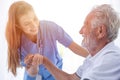 Nurse Medical Staff Worker Support Service Healthcare Senior Elder Man in Home Care happy smile looking together Royalty Free Stock Photo