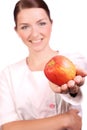 Nurse offering an appleto the camera