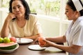 Nurse peeling apple for adult female patient in the room Royalty Free Stock Photo