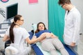 A nurse performs an ultrasound on a pregnant patient under the guidance of the attending doctor. Royalty Free Stock Photo