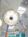 Nurse places surgical lamp on the operating table Royalty Free Stock Photo