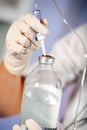 Nurse prepares IV solution for infusion Royalty Free Stock Photo