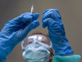 A nurse prepares the vaccine against the Coronavirus Covid 19 to inoculate it to a patient Royalty Free Stock Photo