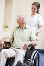 Nurse Pushing Man In Wheelchair