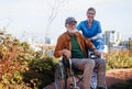 Nurse pushing senior man in wheelchair. Female caregiver and elderly man enjoying a warm autumn day in nursing home. Royalty Free Stock Photo
