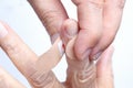 Nurse putting adhesive bandage on elderly hand