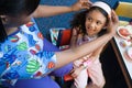 Nurse putting headband on girl