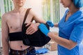 Nurse putting a sling on patients arm that is broken. Injury Royalty Free Stock Photo