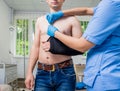 Nurse putting a sling on patients arm that is broken. Injury Royalty Free Stock Photo