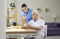 Nurse in retirement home helping demented senior man with brain training activities Royalty Free Stock Photo