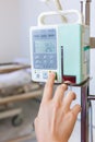 Nurse's hands regulation infusion pump intravenous IV drip. Royalty Free Stock Photo