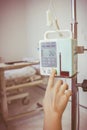 Nurse's hands regulation infusion pump intravenous IV drip. Vign Royalty Free Stock Photo