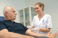 Nurse securing tourniquet to patient`s arm