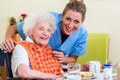 Nurse with senior woman helping with meal Royalty Free Stock Photo