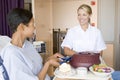 Nurse Serving A Patient A Meal In Her Bed Royalty Free Stock Photo