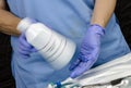 Nurse shaking enteral Nutrition bottle in a hospital, Palliative Care Royalty Free Stock Photo