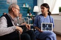 Nurse showing an X-ray on a tablet to a elderly patient Royalty Free Stock Photo